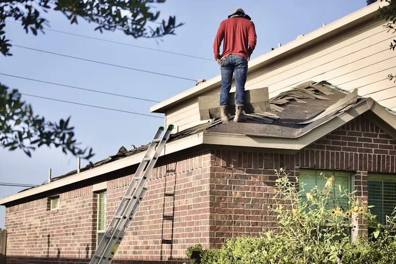 Professional roofer working on a residential roof in Shoreview
